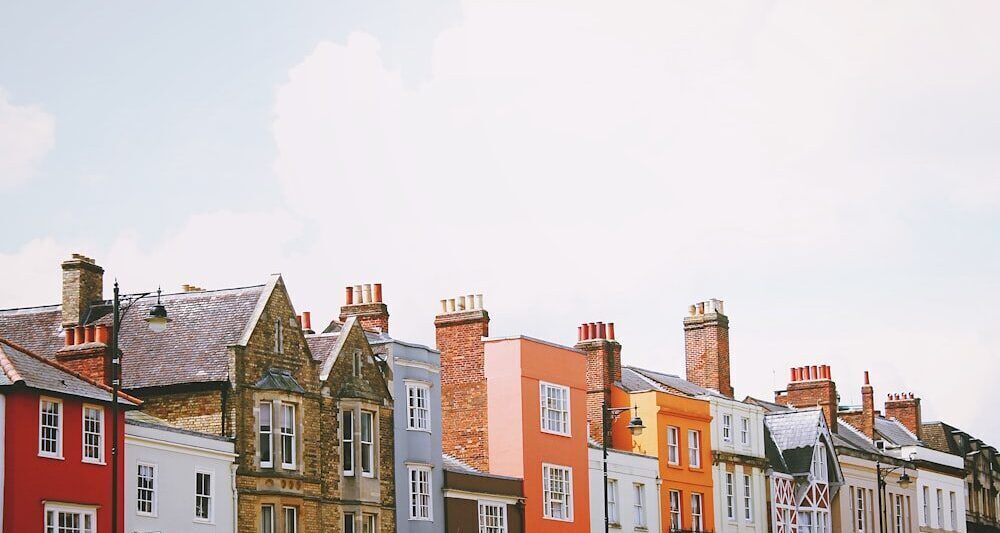 assorted-color concrete houses under white clouds during daytime